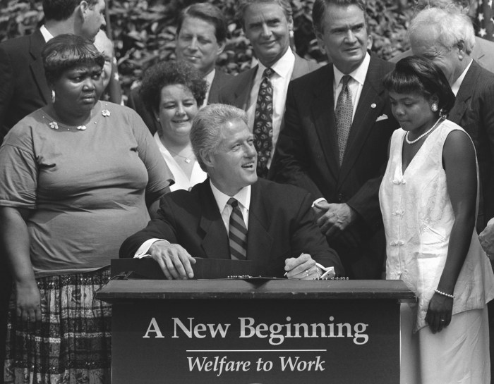 President Clinton prepares to sign legislation in the Rose Garden of the White House Thursday, Aug. 22, 1996, overhauling America's welfare system. Visible, from left, are former welfare recipients Lillie Harden, of Little Rock, Ark., and Janet Ferrel, of West Virginia, Vice President Gore, West Virginia Gov. Gaston Caperton, Sen. John Breaux, D-La., and former welfare recipient Penelope Howard, of Delaware. (AP Photo/J. Scott Applewhite)